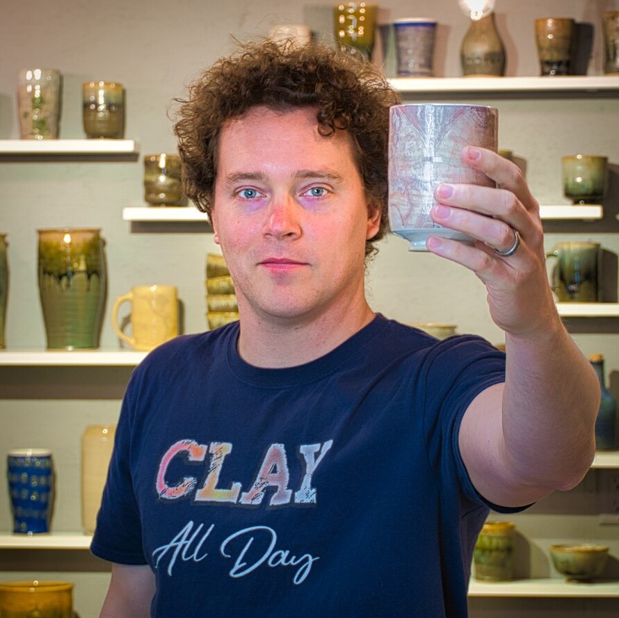 Photo of person holding up pottery