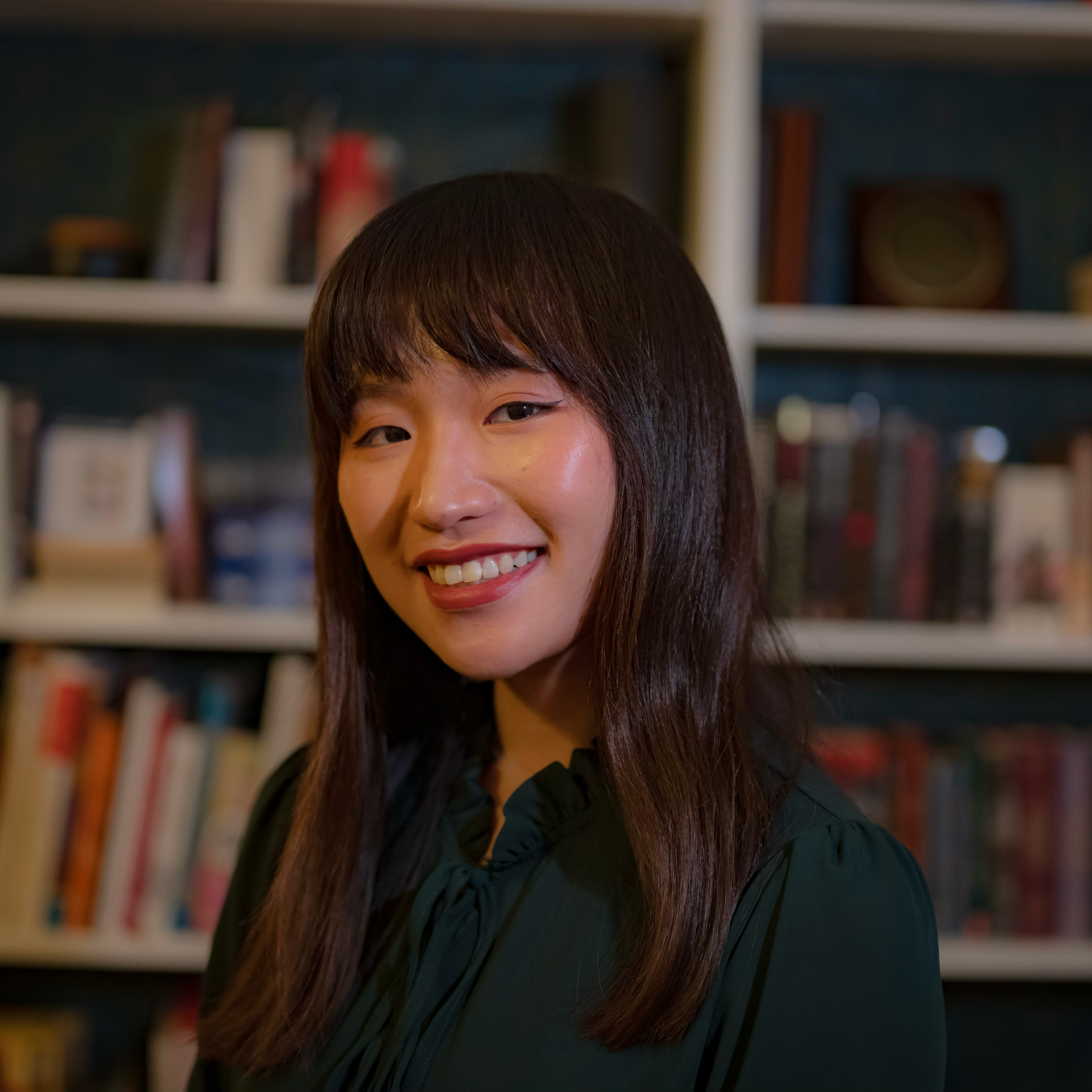 Woman standing in front of bookshelves