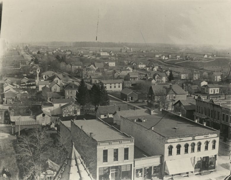 East Main Street view from Courthouse tower. Visible in distance is white frame building housing first Catholic Church. Circa 1900.