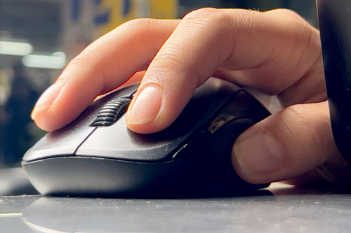 Hand on computer mouse