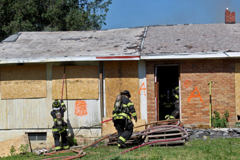Firefighters training with empty house