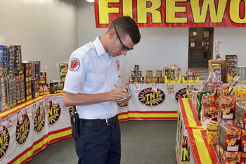 Inspector writes notes in fireworks store