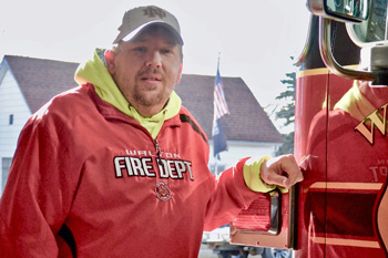 Man standing next to fire truck