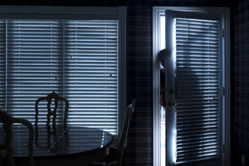 Man entering back door in dark