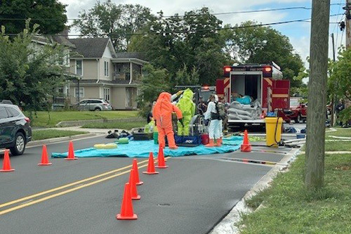 Workers in hazmat suits are sprayed to be decontaminated during Elkhart County LEPC drill
