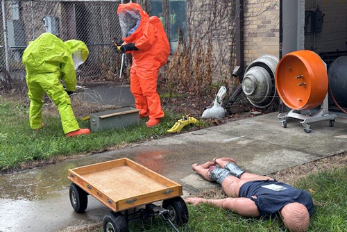 Workers in hazmat suits work with wires during Elkhart County LEPC drill