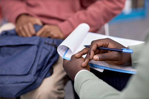 Hands paper pen student conversation