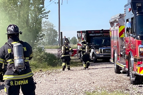 Firefighters carry object from leaking tanker truck