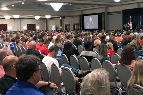 People sit in large conference room attending Day Two of the Advanced Training for the School Safety Specialist Academy