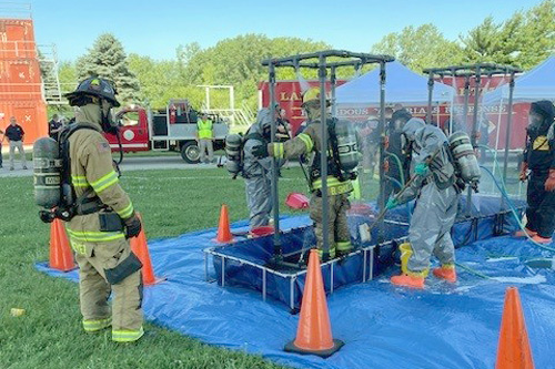 Firefighters decontaminate in shower at Tippecanoe County LEPC drill