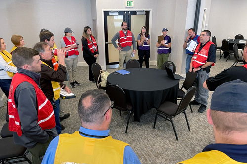 Damage assessment teams at exercise receive instructions