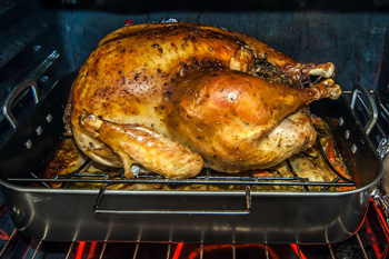 Roasted turkey in pan inside oven