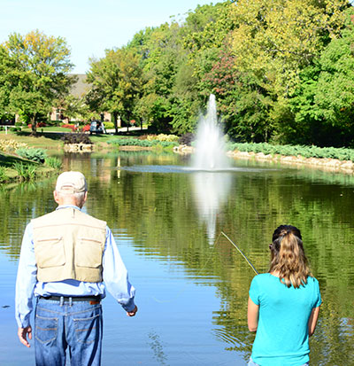 2 people fishing in a pond