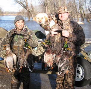 Two duck hunters and a dog