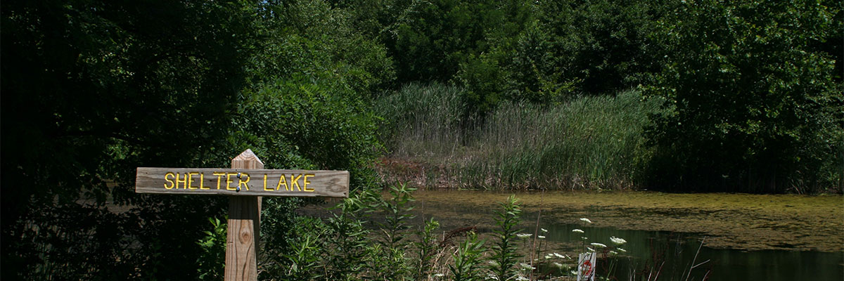 small lake with sign