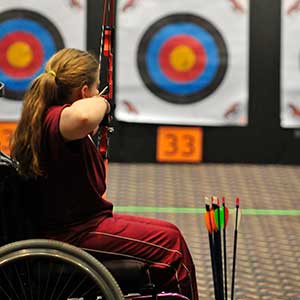 women in wheelchair shooting arrow