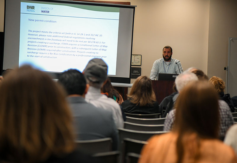 Man presenting slideshow in front of audience