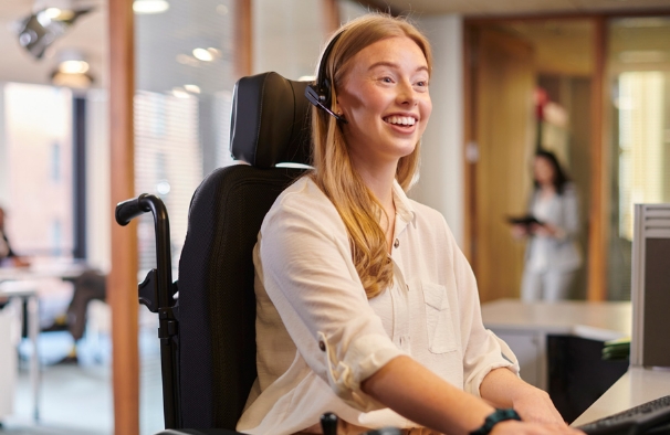 Woman smiling while working at a computer.