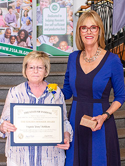 Picture of Virginia "Jenny" Kirkham receiving the award from the Lieutenant Governor