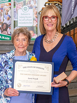 Picture of Lorrie Woycik receiving the award from the Lieutenant Governor