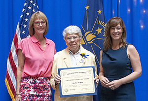 Photo of Marilyn Skinner receiving the award