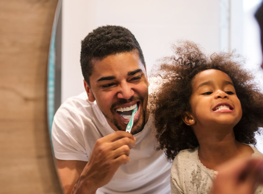 black family brushing teeth