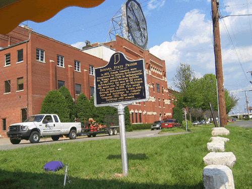 The historical marker is located near the corner of South Clark Boulevard and Woerner Avenue, across the street from the building that served as the Indiana State Prison from 1847 to 1921.
