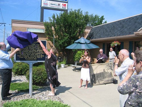 Dale and Pam Longacre, owners of the Elkhart Camera Center, which now stands on the site of the old Conn factory, had the honor of unveiling the marker, while daughter Tiffany played the National Anthem on an original 1880s Conn's coronet.