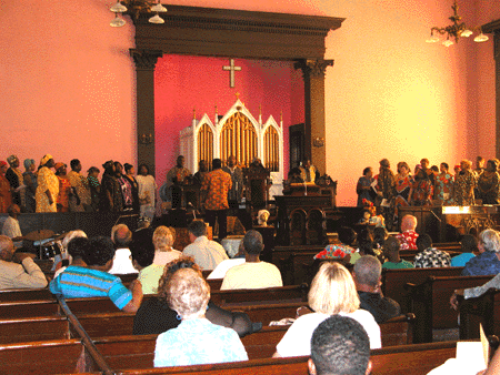 The :Messengers for Christ choir is gathered at the front of the church.