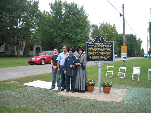 Present owners of the Cravens’ home, Jeff and Cathy Volz, seen here portraying Mrs. Cravens, daughter Alicia Volz, seen here portraying James H. Cravens, and son Raye Smart, who designed the Sesquicentennial logo.