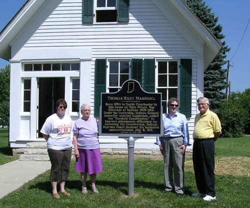 (From left) Carrie Mugford, City Clerk Treasurer; Ferne Baldwin, expert on the Thomas Riley Marshall birth home; Pamela Bennett, Director of the Indiana Historical Bureau; and William Eberly, President of the North Manchester Historical Society and marker applicant with the marker.