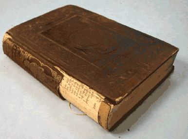 Before and After picture detailing the treatment of an 1852 publisher’s cloth binding from the Library’s Collection