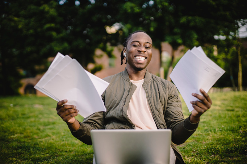 Man with papers and laptop