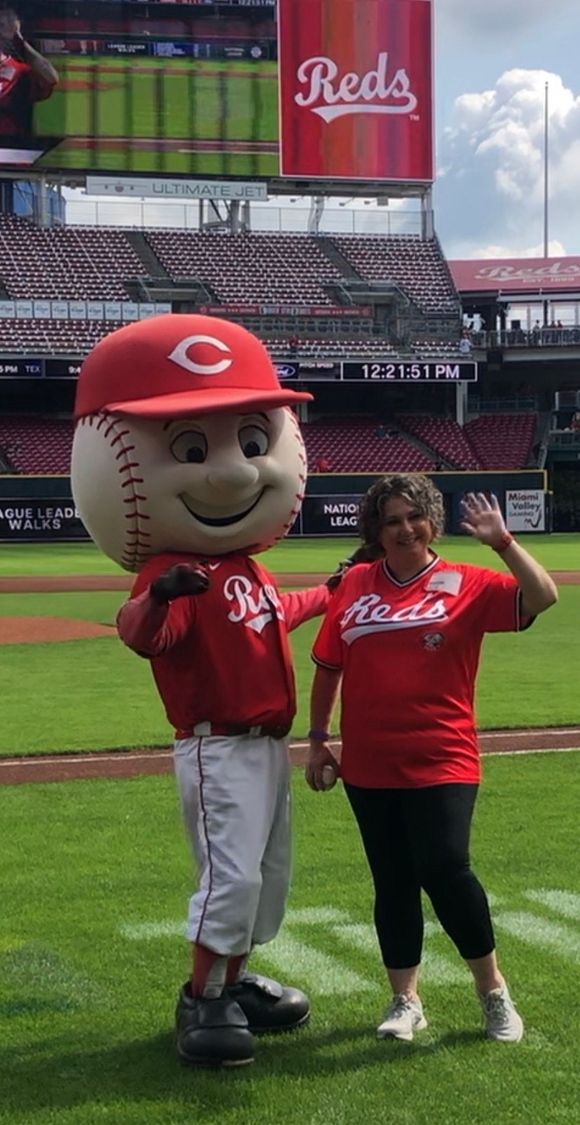 Reds fan poses with mascot